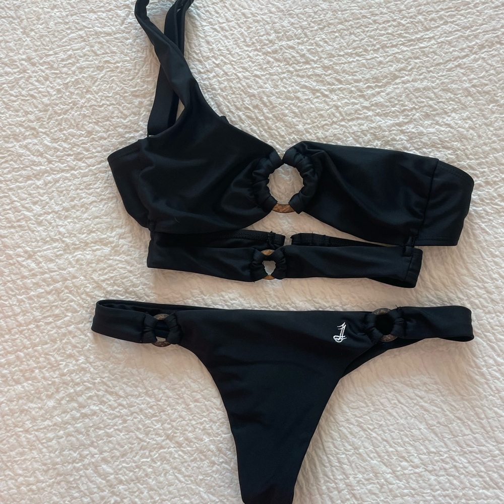 Jumelle Swim black thong bikini set with one shoulder top and wooden rings